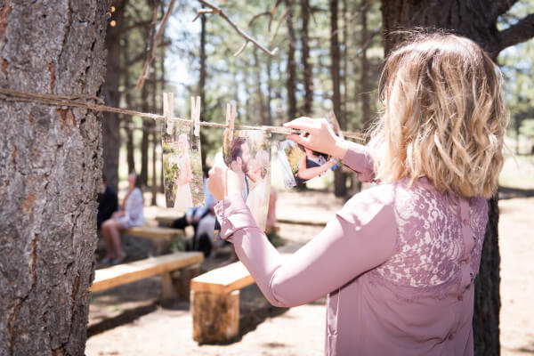 Clotheslines with engagement pictures for a special touch at an outdoor woodland themed wedding. Clotheslines with engagement pictures for a special touch at an outdoor woodland themed wedding.