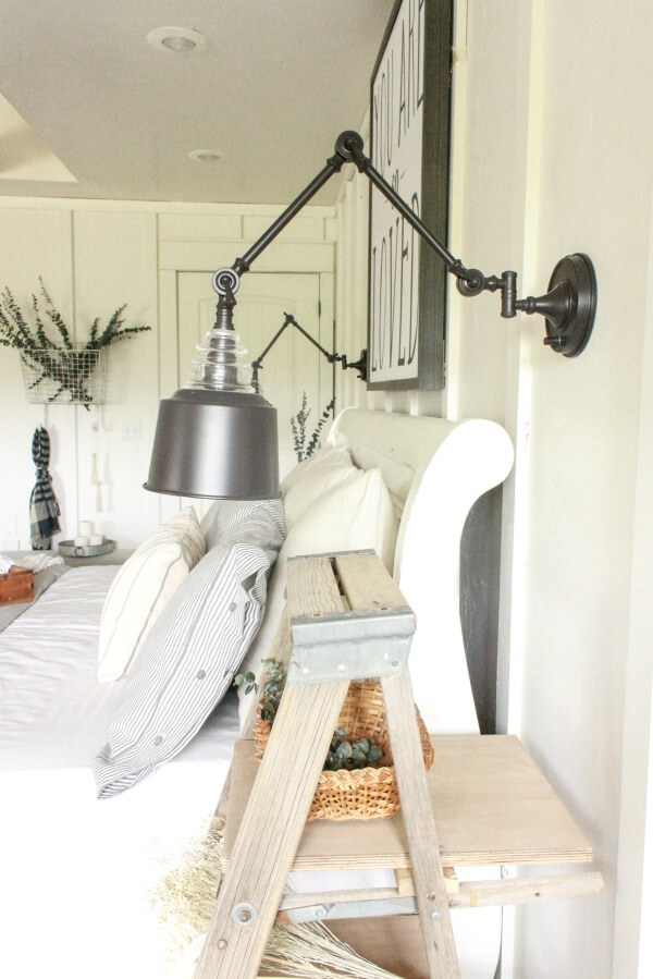 farmhouse master bedroom | swing arm wall lamps | wall lamps | farmhouse bedding | white bedroom | ticking stripe