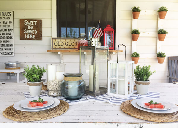 Farmhouse style patriotic outdoor tablescape for the 4th of July. Striped fabric, watermelon, seagrass placemats, and red, white and blue, all on a chippy farmhouse table. Farmhouse style patriotic outdoor tablescape for the 4th of July. Striped fabric, watermelon, seagrass placemats, and red, white and blue, all on a chippy farmhouse table.