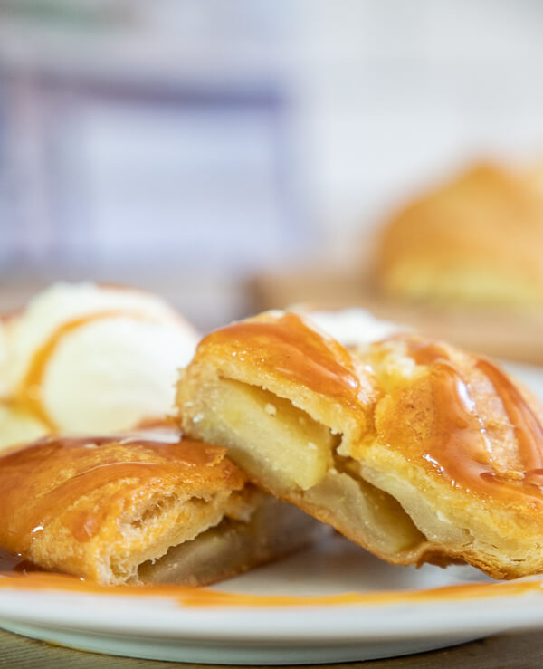 Sweet apple dessert with indulgent cream cheese and homemade caramel sauce wrapped in a crescent roll!