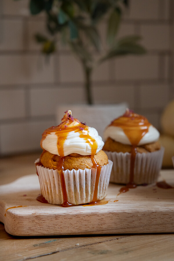 Utterly decadent fall inspired pumpkin cupcakes topped with cream cheese frosting, caramel and sea salt. It has all the flavors of fall!