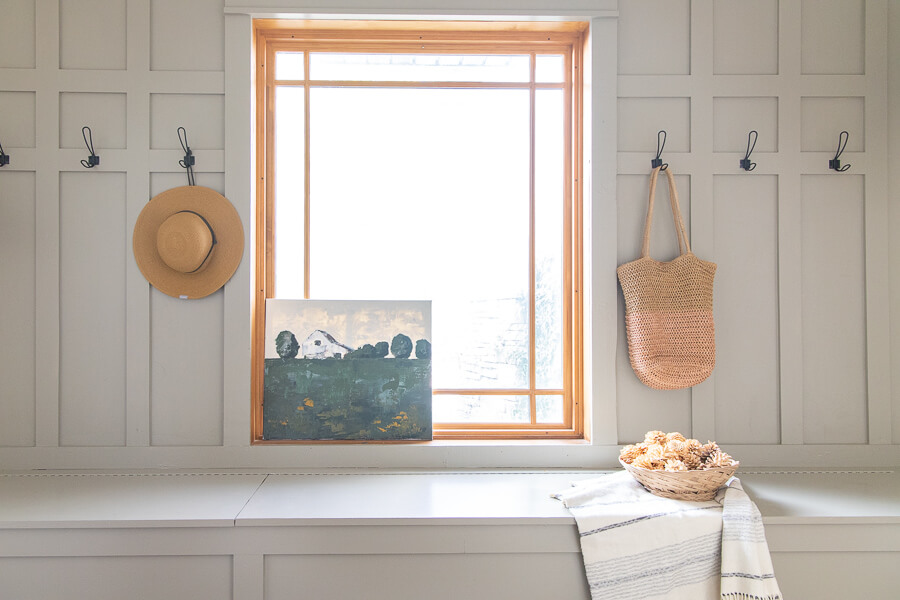 The use of Benjamin Moore Gettysburg Grey on the bench is the perfect color!This breezeway has a great functional design and the mudroom decor is simple and stylish without interfering with the functionality.