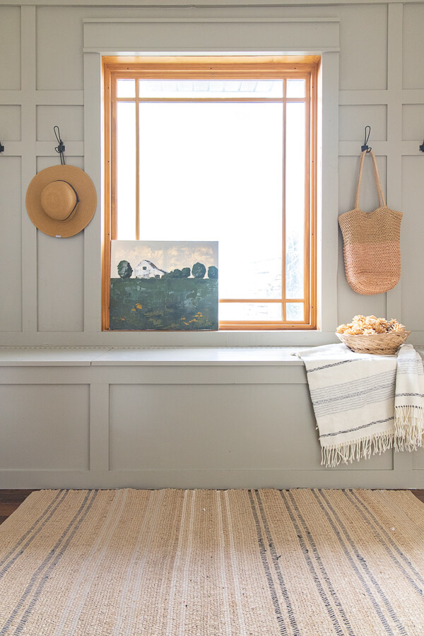 The use of Benjamin Moore Gettysburg Grey on the bench is the perfect color!This breezeway has a great functional design and the mudroom decor is simple and stylish without interfering with the functionality.