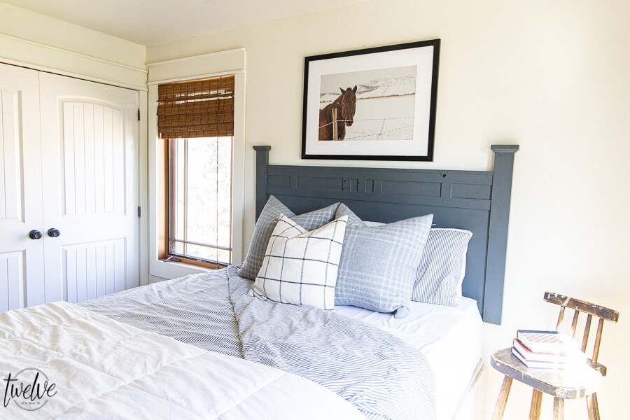 Teenage boys bedroom complete with simple white walls using Benjamin Moore Dove White, ticking strip bedding, grey plaid pillows and some horse photography to round it out.