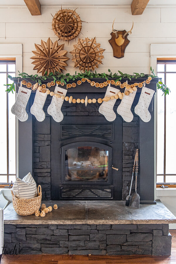 How to paint a stone fireplace with a paint sprayer and give it an updated and modern look in no time! See how I gave my stacked stone fireplace a complete facelift with just a coat of paint.