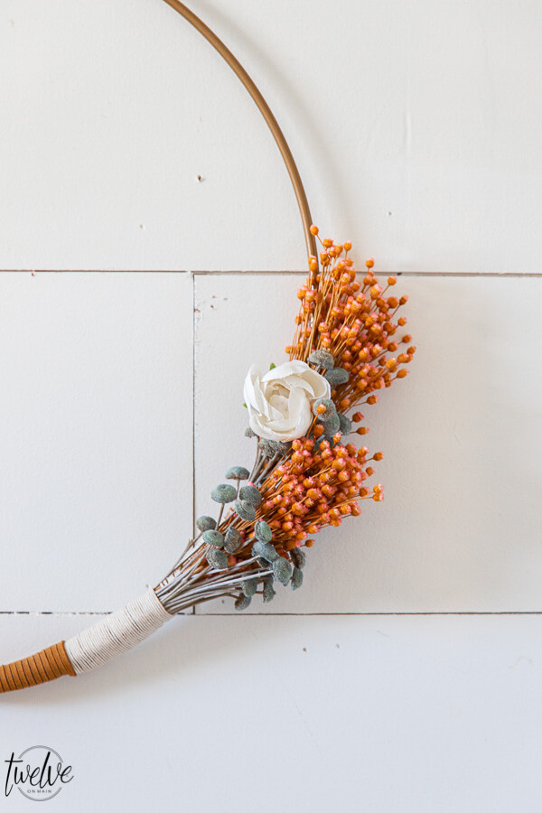 Gorgeous boho style hoop wreath for spring! This has beautiful dried flowers, twine and leather accents and will work in your home for more than just the spring season.