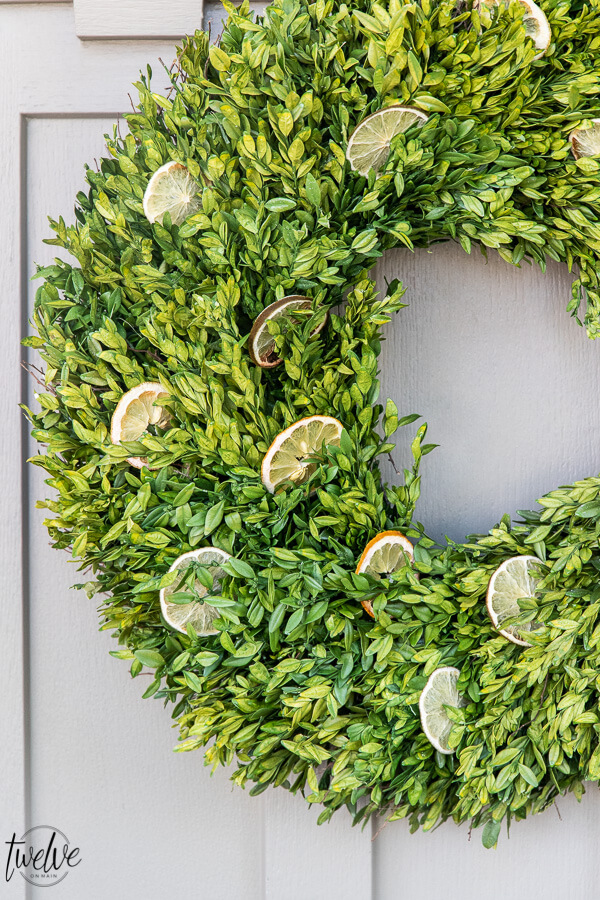 How to make a stylish boxwood and lemon summer wreath perfect for a front door or entry way. It is easy to create and inexpensive!