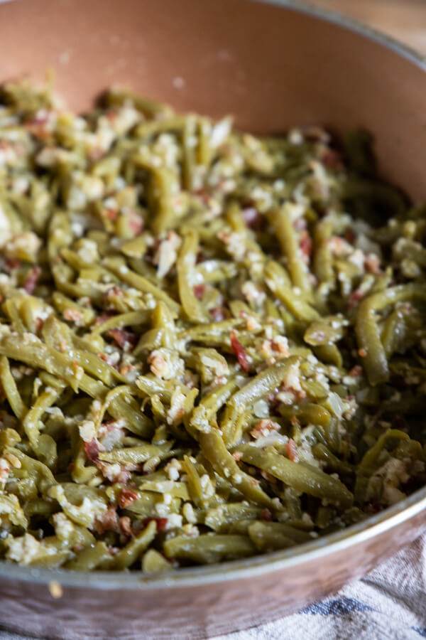 These spicy sauteed green beans with bacon and parmesan is the perfect side dish on busy weeknights or for a holiday party!