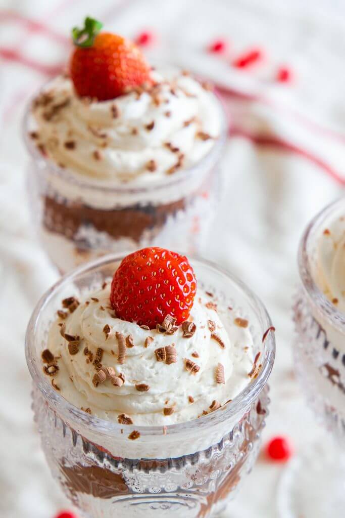 This is the best brownie trifle recipe. With the combination of brownies or chocolate cake, pudding/cool whip filling, strawberries, and homemade chocolate sauce, this is easy to make and looks amazing! It tastes amazing and is a sweet treat to make for Valentines Day or any day. Its a great Valentines dessert, and the individual trifles are adorable!