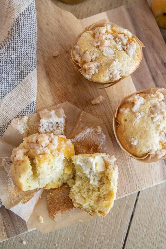 These amazing peach muffins with a cream cheese filling are the perfect way to use those peaches! Peaches and cream muffins for the win.