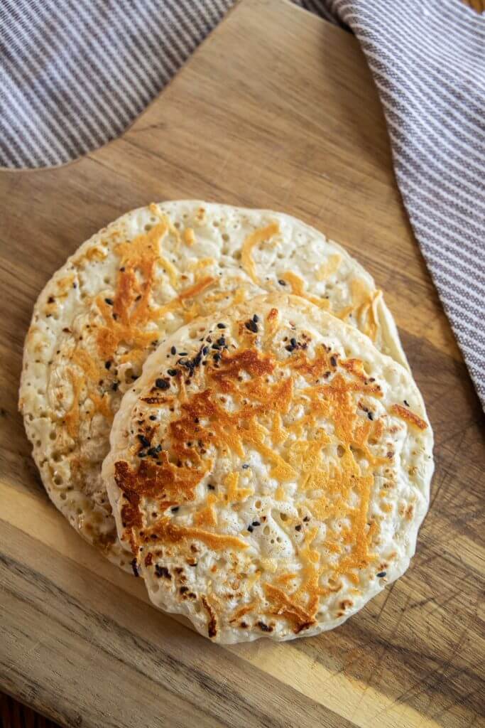 Make this easy 2 ingredient sourdough flatbread recipe. It is quick and easy, can be made in 5 minutes and has all the benefits of sourdough. Top with your favorite seasonings and enjoy!