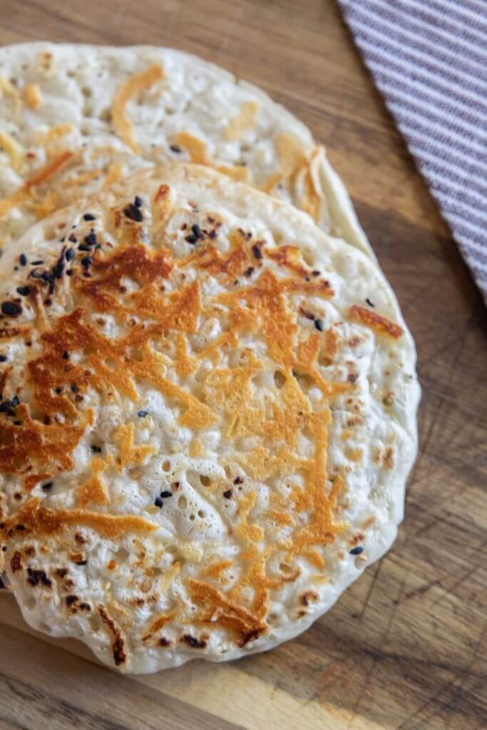 Make this easy 2 ingredient sourdough flatbread recipe. It is quick and easy, can be made in 5 minutes and has all the benefits of sourdough.  Top with your favorite seasonings and enjoy!