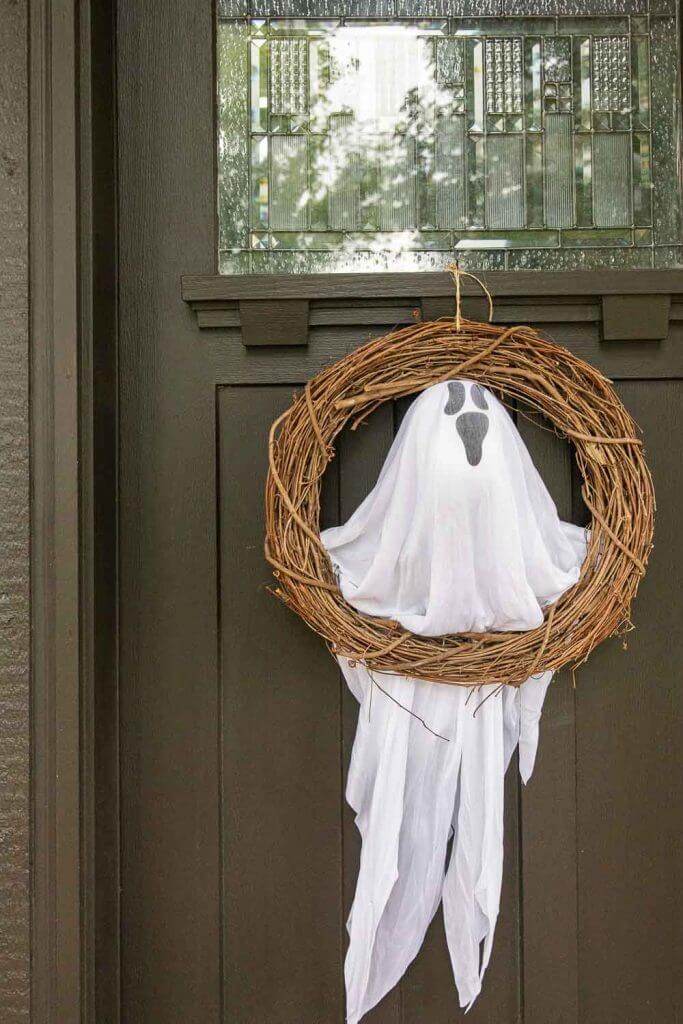 This ghost Halloween door wreath DIY using Dollar Tree items is the cutest and most affordable Halloween decor this year!!