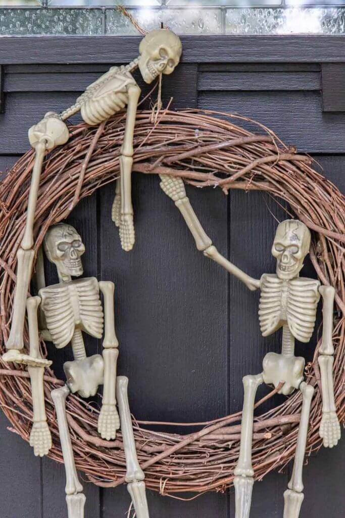 How to make a Halloween wreath using dollar store skeletons! This is a super easy Halloween wreath DIY tutorial.
