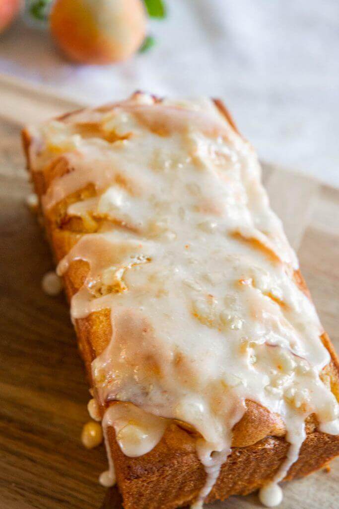 Make this amazing peach bread recipe with fresh or frozen peaches! This bread tastes amazing and has a flavorful peach glaze too! This tender and sweet bread with bite-sized peach pieces dotting the bread, its sweet, tangy and ofh so flavorful!