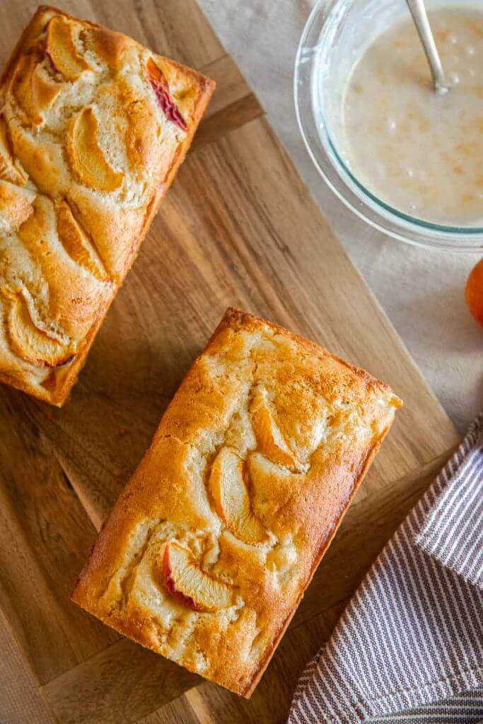 Make this amazing peach bread recipe with fresh or frozen peaches! This bread tastes amazing and has a flavorful peach glaze too! This tender and sweet bread with bite-sized peach pieces dotting the bread, its sweet, tangy and ofh so flavorful!