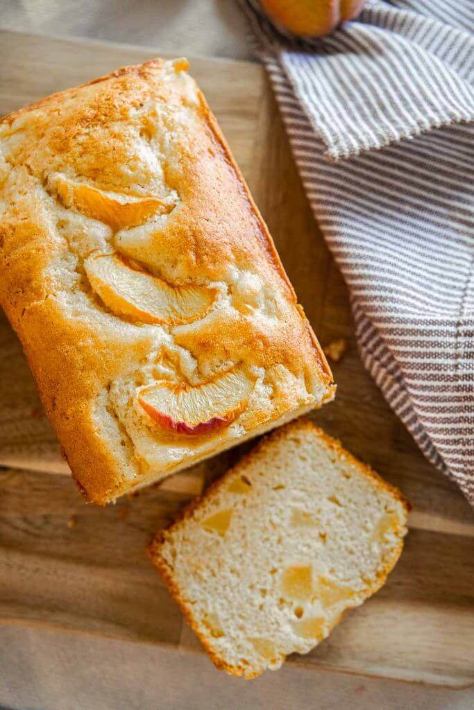 Make this amazing peach bread recipe with fresh or frozen peaches! This bread tastes amazing and has a flavorful peach glaze too! This tender and sweet bread with bite-sized peach pieces dotting the bread, its sweet, tangy and ofh so flavorful!