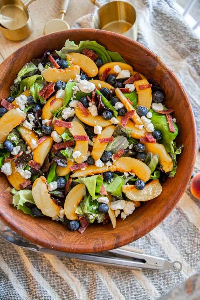 Make this fresh peach salad with bacon, blueberries, feta cheese and balsamic dressing. The combination creates a flavorful salad.