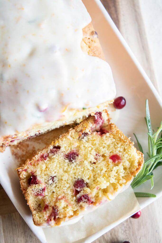Make this amazing cranberry sweet bread with an orange rosemary glaze. This bread is sweet, tender with burst of tart cranberry. With the inclusion of orange and rosemary in the bread as well as in the glaze, this bread has an amazing flavor and texture. Make this for your next holiday get together!