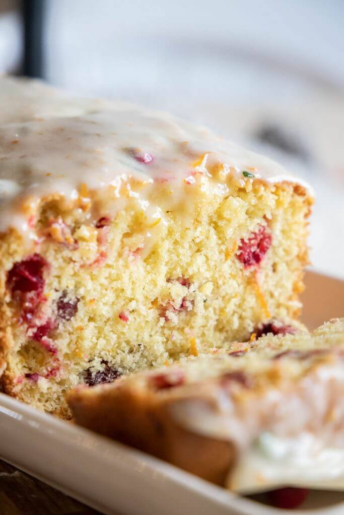 Make this amazing cranberry sweet bread with an orange rosemary glaze. This bread is sweet, tender with burst of tart cranberry. With the inclusion of orange and rosemary in the bread as well as in the glaze, this bread has an amazing flavor and texture. Make this for your next holiday get together!