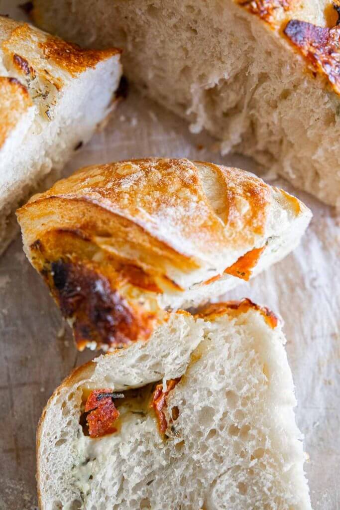 Make this amazing sourdough pizza bread with all the amazing toppings mixed right into the bread! Dip it in marinara sauce for a fun dinner!