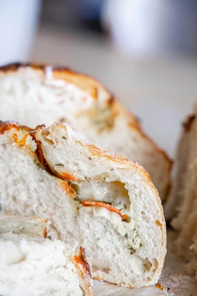 Make this amazing sourdough pizza bread with all the amazing toppings mixed right into the bread! Dip it in marinara sauce for a fun dinner!