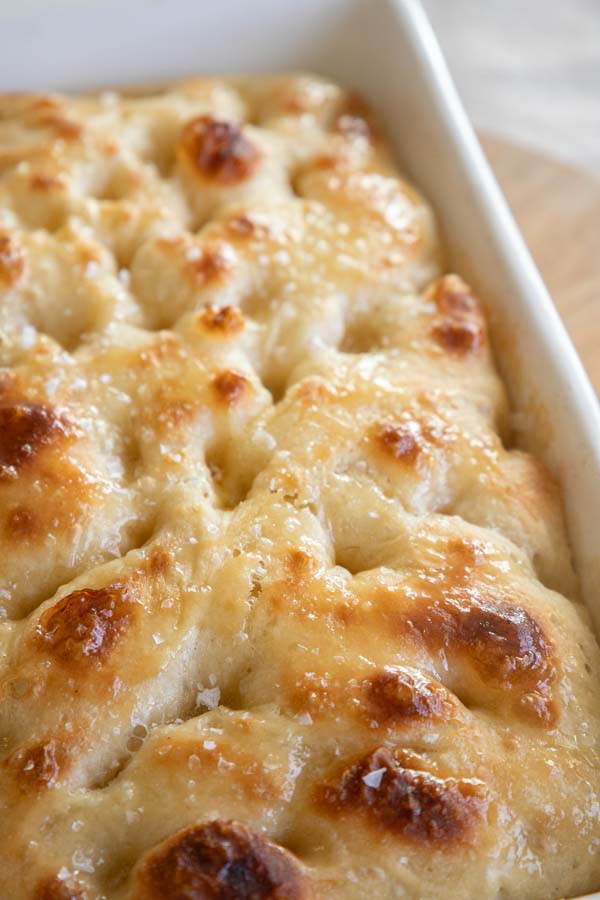 This amazing honey butter sourdough focaccia bread recipe is a glorious take on my regular sourdough focaccia bread. It is light and airy with a sweet buttery glaze on top that makes it unable to resist.