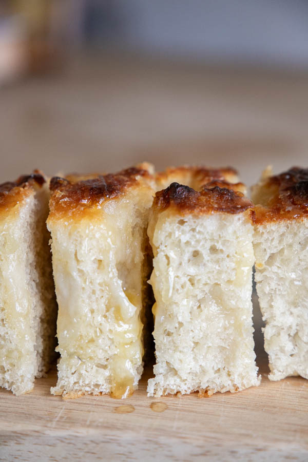 This amazing honey butter sourdough focaccia bread recipe is a glorious take on my regular sourdough focaccia bread. It is light and airy with a sweet buttery glaze on top that makes it unable to resist.