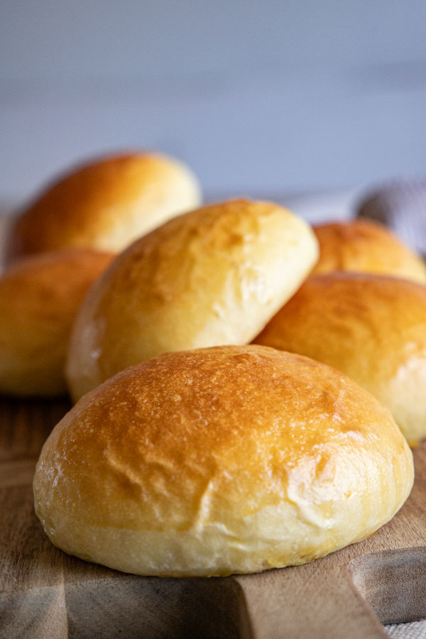These sourdough brioche hamburger buns are the perfect vessel to make the perfect burger! The soft, buttery buns are sturdy enough to handle a large burger patty and all the fixings.