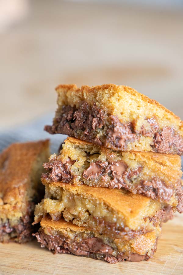 Make these amazing sourdough chocolate chip cookie bars and bring the best treat to your next party! These are super easy to make, no mixer needed. They are decadent, ooey and gooey. Bake them in your cast iron skillet for an even better crispy crust. These are such a popular treat at our house!