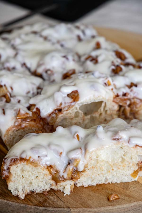 This amazing apple pie sourdough focaccia bread recipe is a glorious take on my regular sourdough focaccia bread. It is light and airy with a sweet and cinnamon spiced apple topping and elevated even more with the addition of a cream cheese icing drizzle.