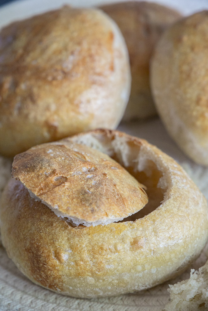 Turn homemade sourdough into beautiful bread bowls! This easy step-by-step guide shows you how to make crusty sourdough bread bowls that are perfect for soup, chili, chowder, and more. Save this recipe for cozy comfort food season!