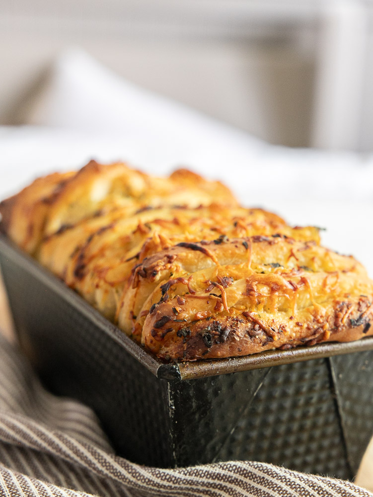 Try this delicious sourdough pull apart bread with herbs and Parmesan. Perfect for sharing at any gathering or party.